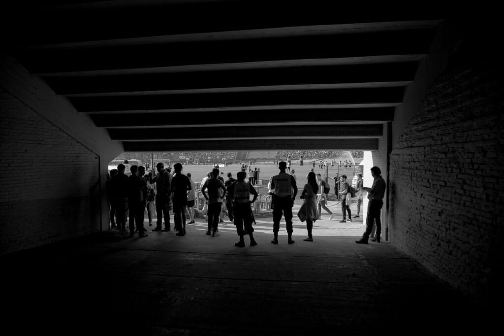 people, entrance, tunnel, stadium, black and white, human figures, figures, unemployed, shows, spectators, monochrome, group, adult, male, policeman, watchman, grandstand, swollen, sport, fan, competition, sporting event, football, play, sports display, centenary, sports, cup, stairs, champion, natural